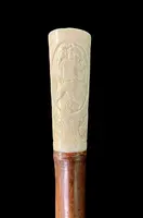 Cane with an ivory "plume" knob featuring cherubs engraved within three ovals