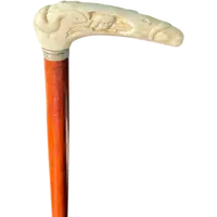 A staff with a side handle in the shape of a tau, made of ivory and depicting a snake hunting inside a tree trunk.