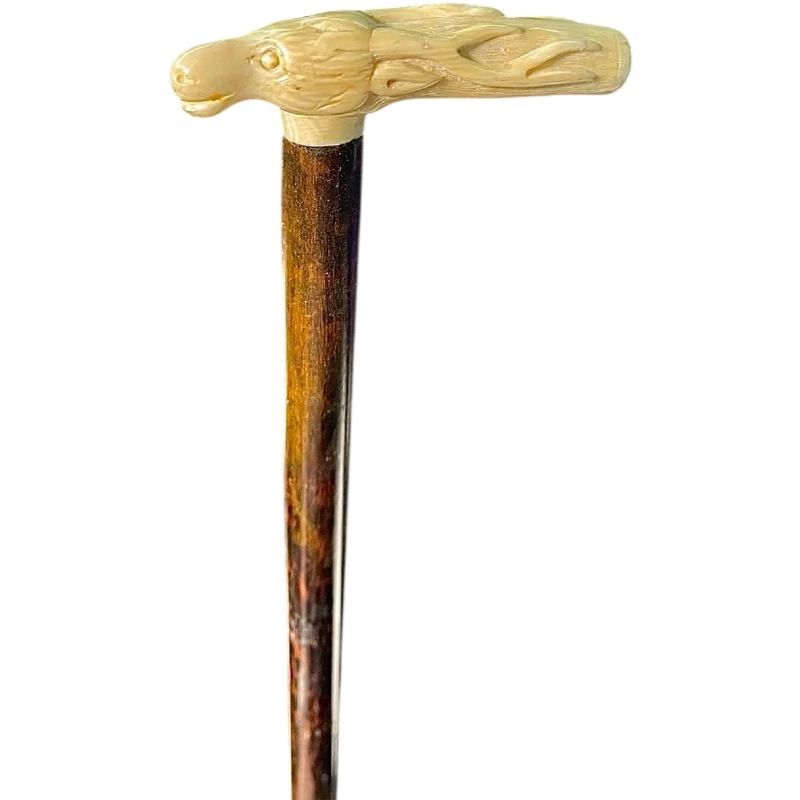 A walking stick with a side-mounted tau-shaped handle depicting a deer's head.