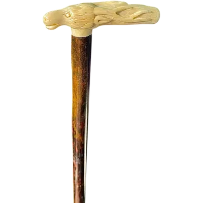 A walking stick with a side-mounted tau-shaped handle depicting a deer's head.