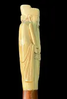A walking stick with an ivory pommel depicting an Asian male figure.