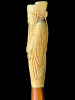 A walking stick with an ivory pommel depicting an Asian male figure.