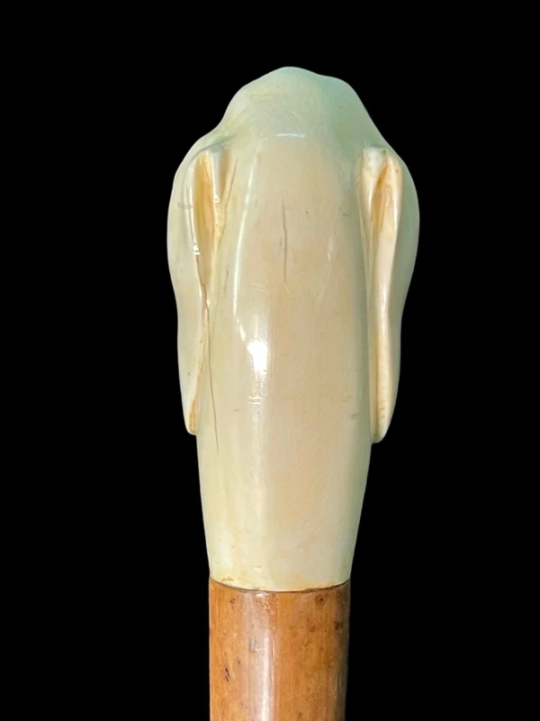 A walking stick with a knob shaped like a dog's head.