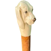 A walking stick with a knob shaped like a dog's head.