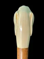 A walking stick with a knob shaped like a dog's head.