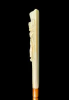 A walking stick with a "plume" knob featuring a high-relief figure of a child playing with a cat.