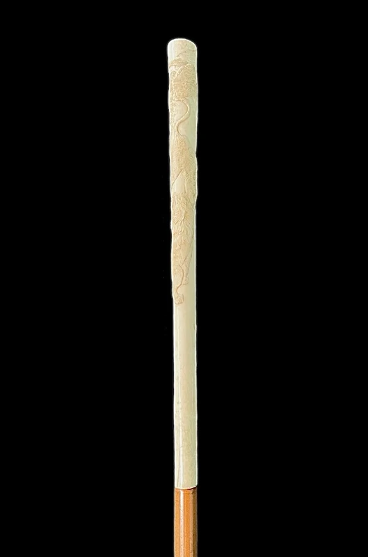 An evening cane with an ivory “plume” knob engraved with lions in bas-relief.