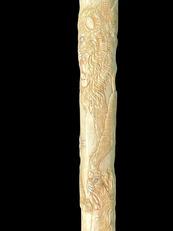 An evening cane with an ivory “plume” knob engraved with lions in bas-relief.