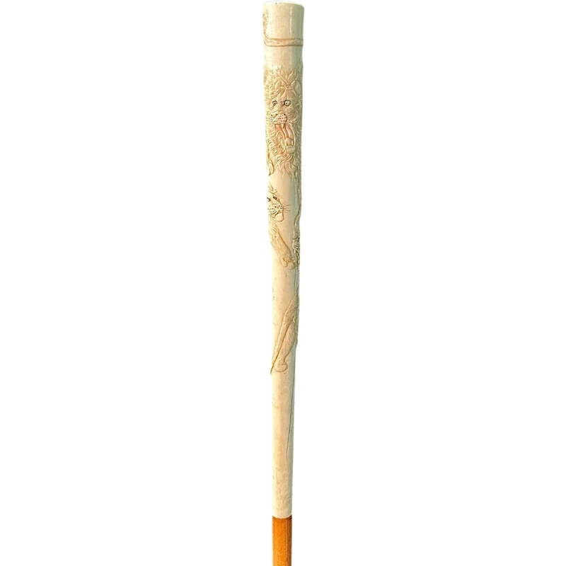 An evening cane with an ivory “plume” knob engraved with lions in bas-relief.