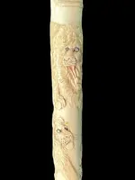 An evening cane with an ivory “plume” knob engraved with lions in bas-relief.