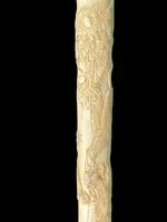 An evening cane with an ivory “plume” knob engraved with lions in bas-relief.