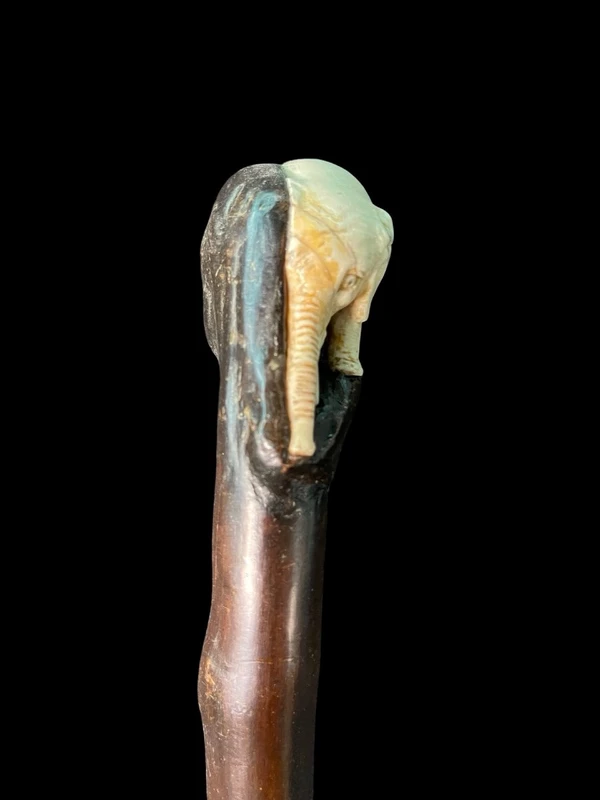 A walking stick with a partially ivory pommel featuring an elephant figure in high relief.