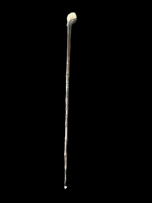 A walking stick with a partially ivory pommel featuring an elephant figure in high relief.