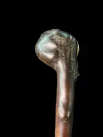 A walking stick with a partially ivory pommel featuring an elephant figure in high relief.