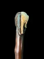 A walking stick with a partially ivory pommel featuring an elephant figure in high relief.