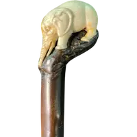 A walking stick with a partially ivory pommel featuring an elephant figure in high relief.