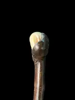 A walking stick with a partially ivory pommel featuring an elephant figure in high relief.