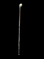 A walking stick with a partially ivory pommel featuring an elephant figure in high relief.