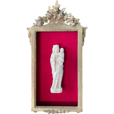 A bas-relief sculpture in ivory depicting the Madonna and Child.