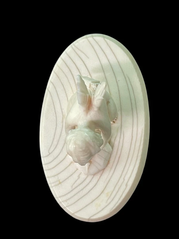 Petite sculpture en ivoire représentant Cupidon en train d'aiguiser