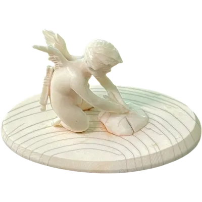 Small ivory sculpture depicting Cupid sharpening