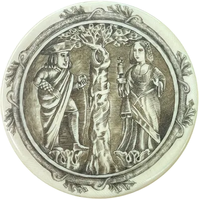 A small ivory box with a lid engraved with a romantic scene.