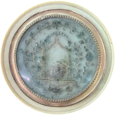 A small ivory box featuring a medallion with neoclassical motifs.