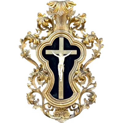 An ivory sculpture of Christ with a carved wooden frame decorated with gold leaf.