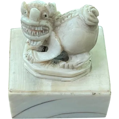 Ivory seal with a handle shaped like a grotesque animal.