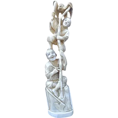 An “okimono” ivory sculpture depicting two male figures with an eagle.