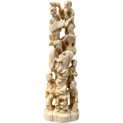 Okimono ivory sculpture featuring figures and a carp.