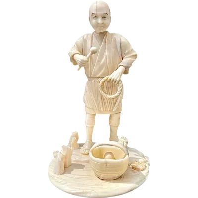 An okimono sculpture carved from ivory depicting a male figure with a braid and a basket.