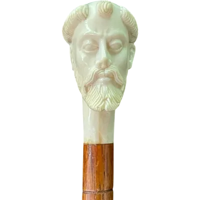 A walking stick with an ivory pommel depicting a monk's head.