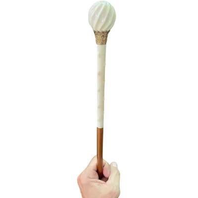 A walking stick with an ivory knob, featuring a round, spiral-shaped section and a spiked shaft.