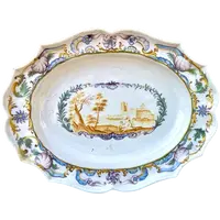 Oval plate with a lobed rim and a border decorated with plant motifs and rocaille.