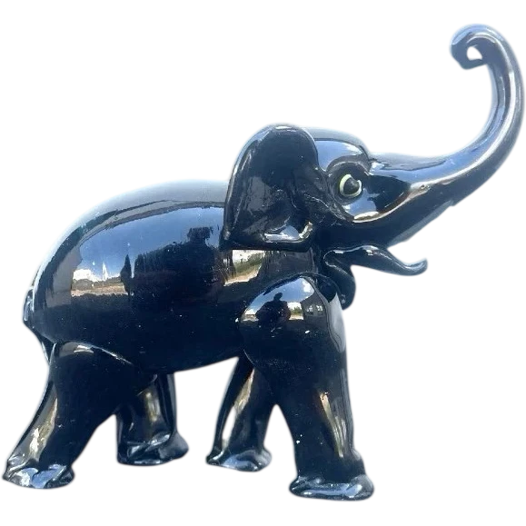 Black glass elephant with milky glass tusks. Made by Toso. Murano. 11x10x5 cm.