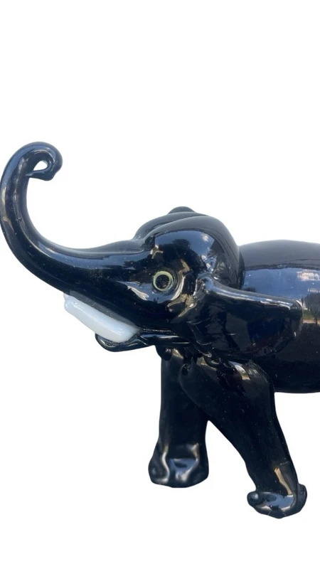 Black glass elephant with milky glass tusks. Made by Toso. Murano. 11x10x5 cm.