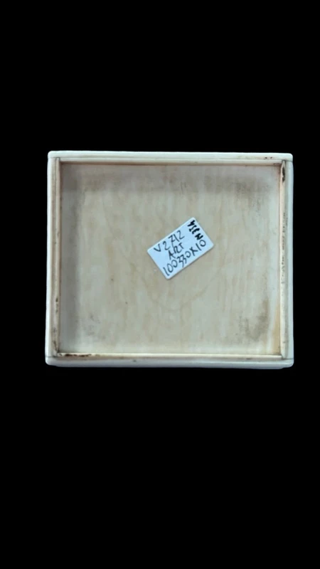 A small ivory box with a lid engraved with two monkeys in high relief.