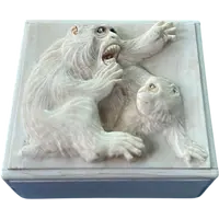 A small ivory box with a lid engraved with two monkeys in high relief.