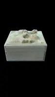 A small ivory box with a lid engraved with two monkeys in high relief.