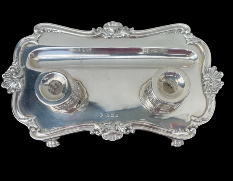 Calamaio in argento a piedi leonini e motivi rocaille e vegetali art nouveau.