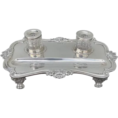 Silver inkwell with lion-shaped feet and Art Nouveau rocaille and floral motifs.