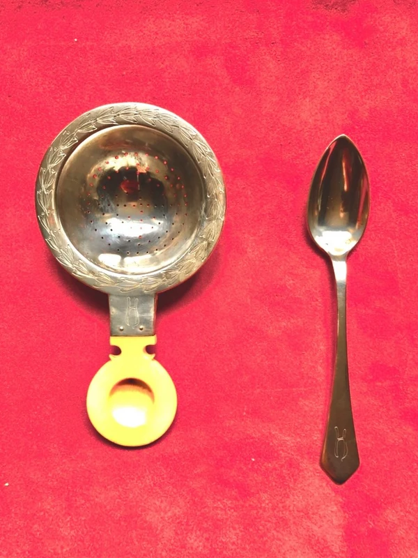 Set of six silver teaspoons with a silver tea strainer engraved with initials