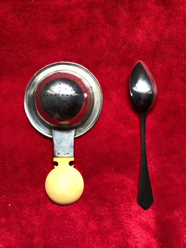 Set of six silver teaspoons with a silver tea strainer engraved with initials