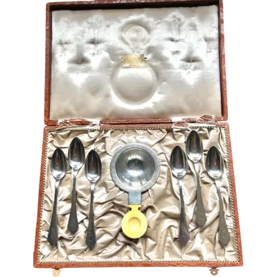 Set of six silver teaspoons with a silver tea strainer engraved with initials