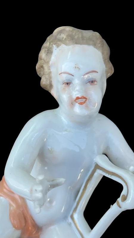A series of four porcelain musicians seated on columns.