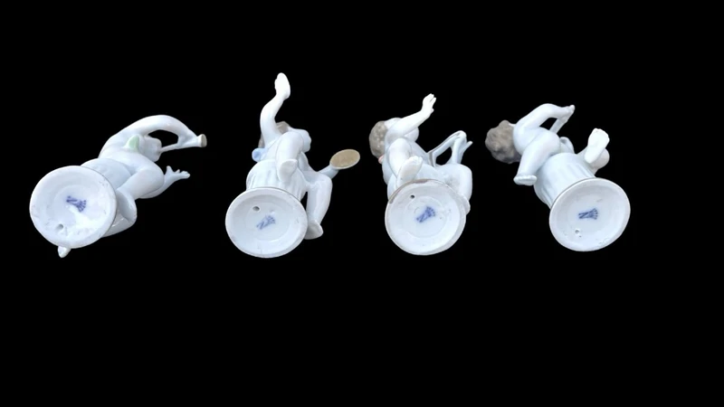 A series of four porcelain musicians seated on columns.