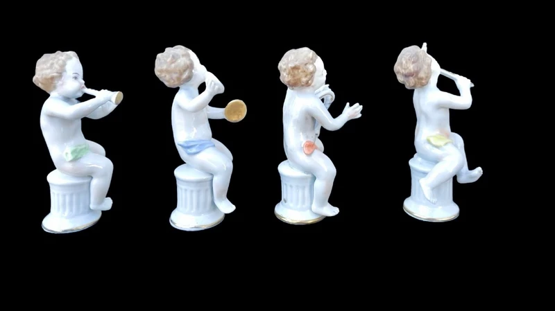 A series of four porcelain musicians seated on columns.