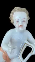 A series of four porcelain musicians seated on columns.