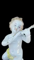 A series of four porcelain musicians seated on columns.